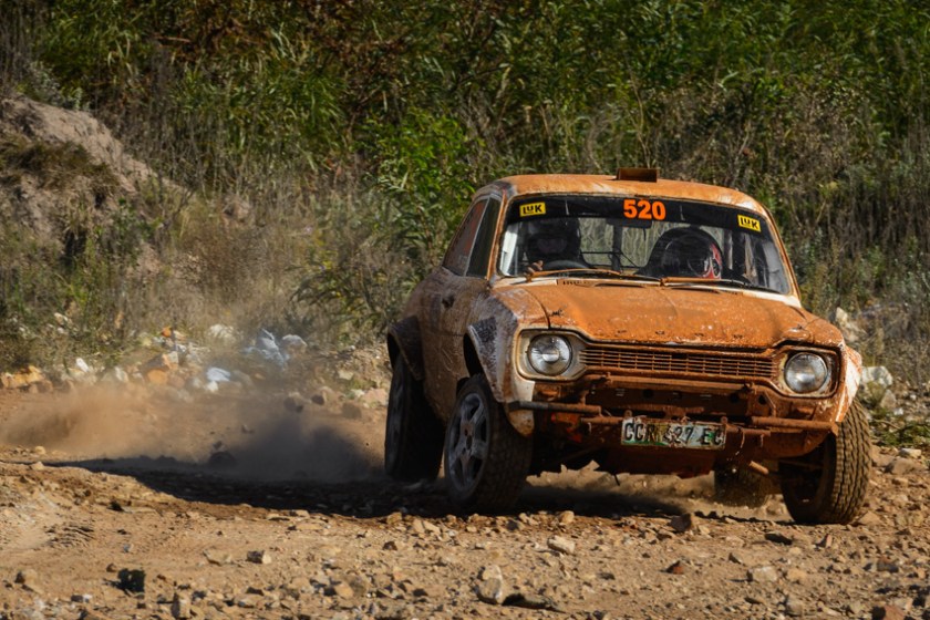 A Ford Escort rally car in action on gravel