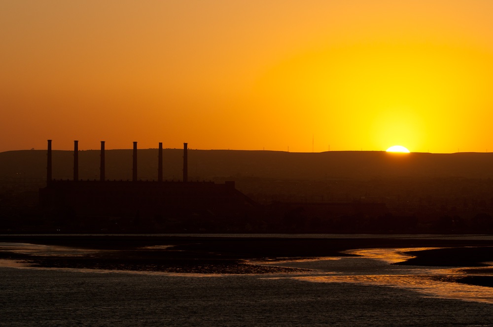 sunset near a power station